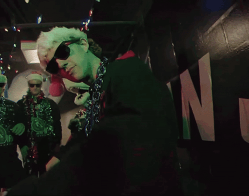Man in Sunglasses and Santa Hat Dancing in Dark Room