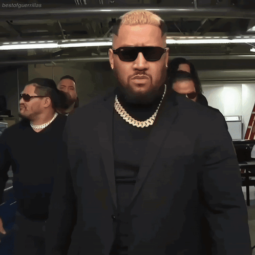 Man In Sunglasses And Suit In Line GIF