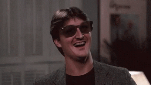 Man In Sunglasses And Suit Laughing And Smiling GIF