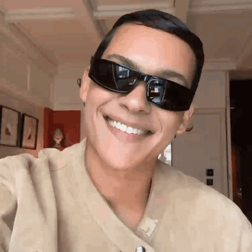 Man in Sunglasses and Tan Shirt Smiling