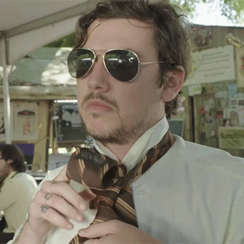Man in Sunglasses and Tie With Wrist Tattoo