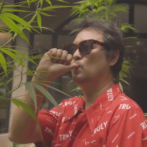 Man in Sunglasses and Truly Shirt