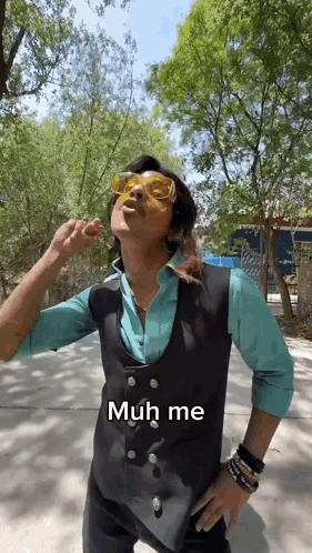 Man in Sunglasses and Vest Says Muh Me