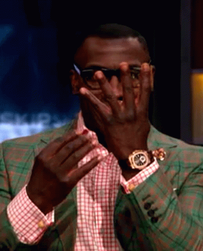 Man in Sunglasses and Watch Covering Eyes