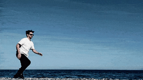 Man In Sunglasses And White Shirt On Beach GIF