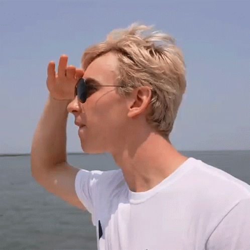 Man In Sunglasses And White Shirt Over Water GIF