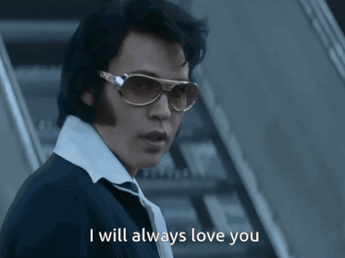 Man in Sunglasses and White Shirt Saying I Will Always Love You