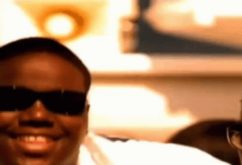 Man in Sunglasses and White Shirt Smiling