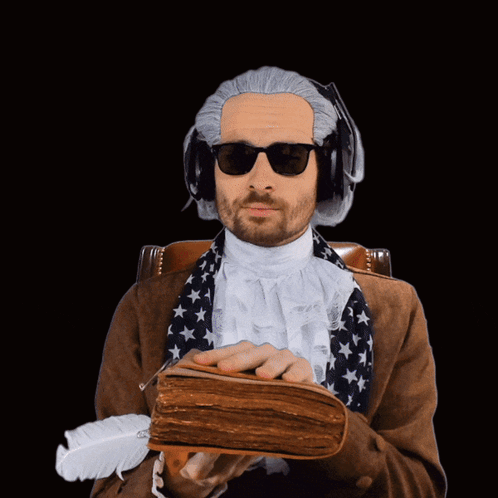 Man In Sunglasses And Wig Holding Book GIF