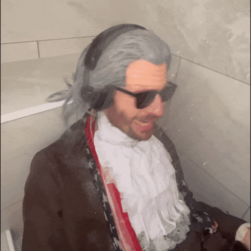 Man in Sunglasses and Wig in Bathroom