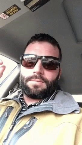 Man In Sunglasses And Yellow Jacket In Car No Smoking Sticker GIF