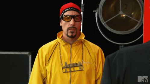 Man in Sunglasses and Yellow Jacket With MTV Logo