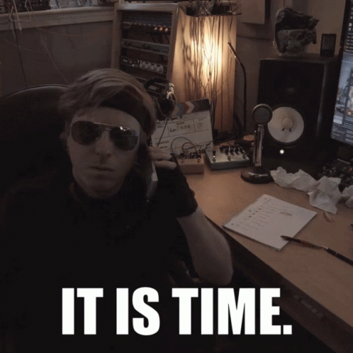 Man in Sunglasses at Desk Saying It Is Time