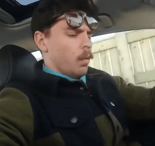 Man in Sunglasses Driving Car