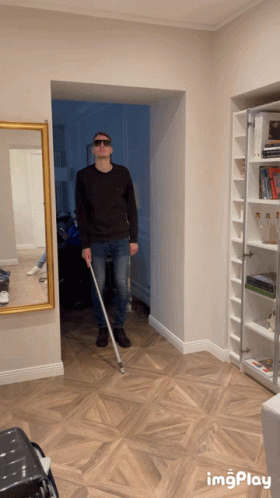 Man in Sunglasses Holding Cane