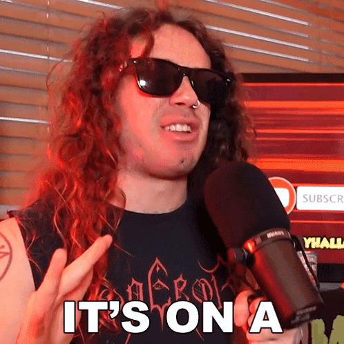 Man in Sunglasses Holding Microphone Saying Its On