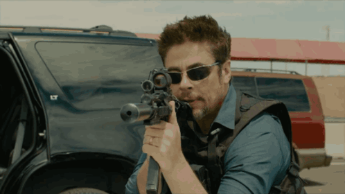 Man in Sunglasses Holding Rifle by Car with LT
