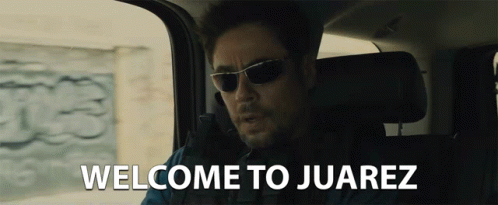 Man in Sunglasses in Car Welcome to Juarez