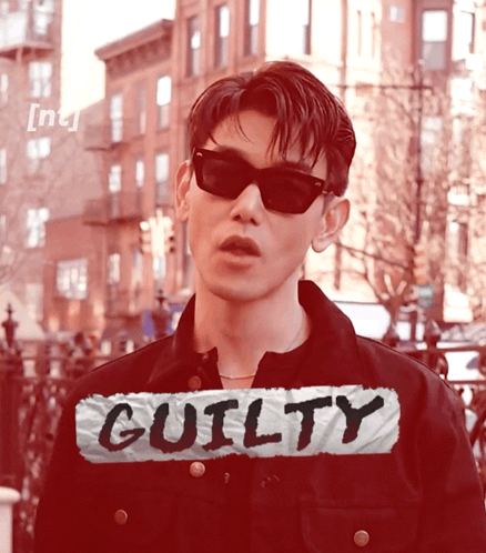 Man In Sunglasses In Front Of Guilty Sign GIF