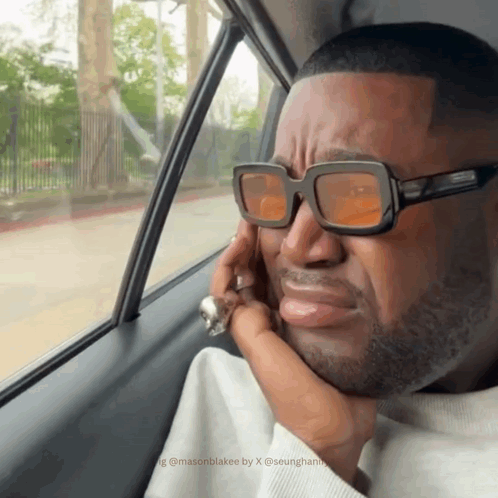 Man in Sunglasses Looking Out Car Window