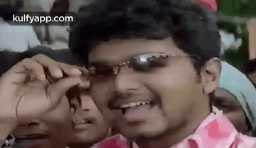 Man in Sunglasses Making Funny Face in Front of Crowd