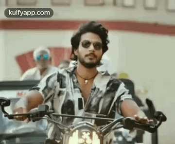 Man in Sunglasses Riding Motorcycle