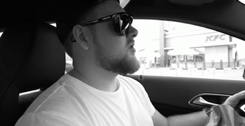 Man In Sunglasses Sitting In Car In Front Of KFC GIF