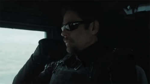 Man in Sunglasses Sitting in Dark Room