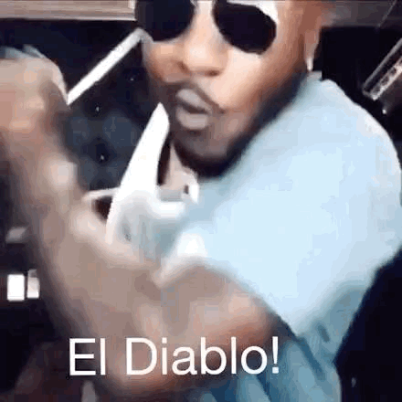 Man in Sunglasses Smoking Cigarette Saying El Diablo