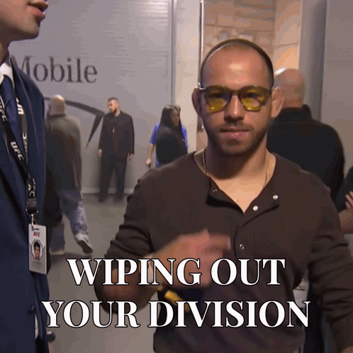 Man in Sunglasses Standing Before Mobile Sign