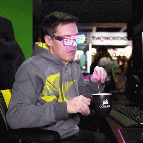Man in Sunglasses Stirring Coffee From Corsair Mug