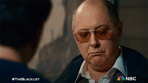 Man In Sunglasses Talking To Man With NBC Logo GIF