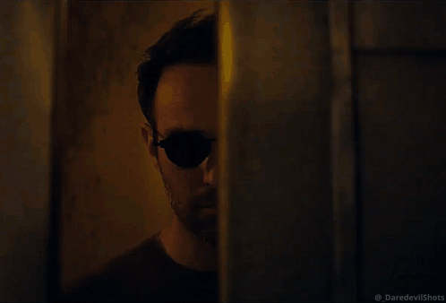 Man in Sunglasses Walking in Dark