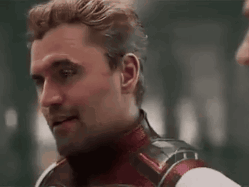 Man in Superhero Costume Looking at Another Man