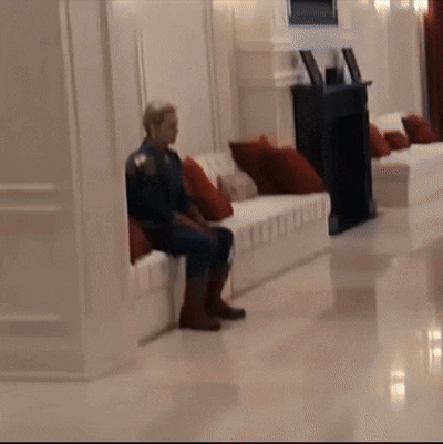Man in Superhero Costume Sitting on Couch
