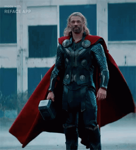 Man in Superhero Costume Standing in Sand