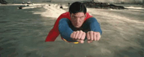 Man in Superman Costume Flying Over Water