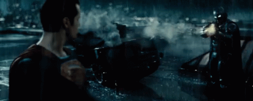 Man in Superman Costume Holding Gun in Water