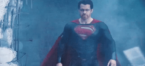 Man In Superman Costume In Dark Room GIF