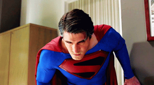 Man in Superman Costume in Front of Wall