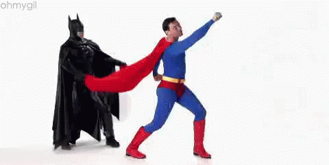 Man In Superman Costume Next To Batman GIF