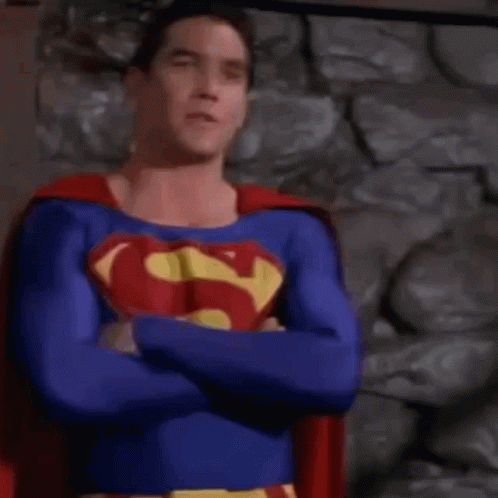 Man in Superman Costume Standing in Front of Building
