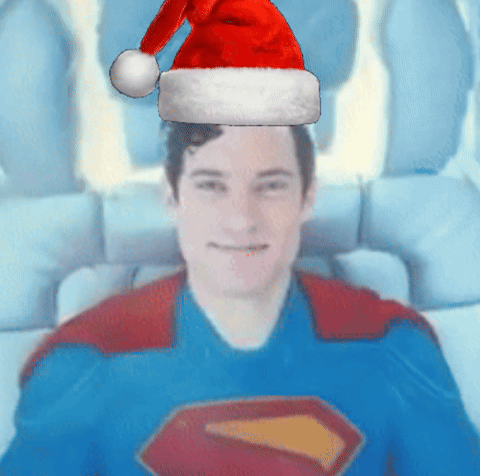 Man in Superman Costume With Santa Hat