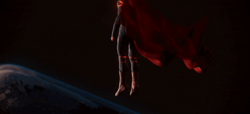Man in Superman Suit in Front of Planet