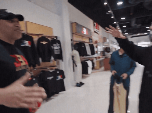 Man in Supreme Shirt Talking to Another Man