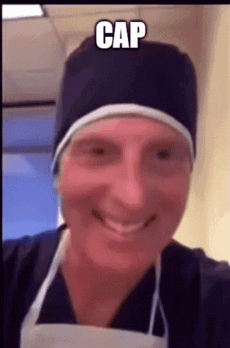 Man in Surgical Cap and Apron Smiling
