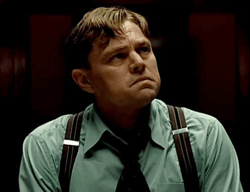 Man In Suspenders And Tie Looking Down GIF