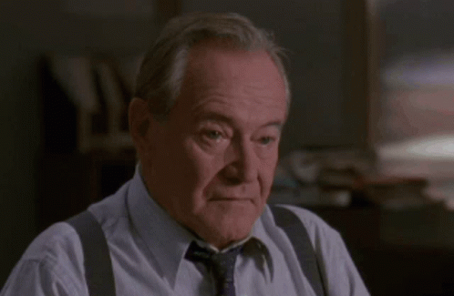Man In Suspenders And Tie Wiping Nose GIF