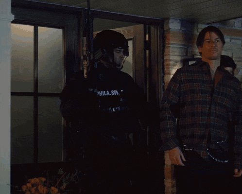 Man In SWAT Uniform In Front Of Building GIF