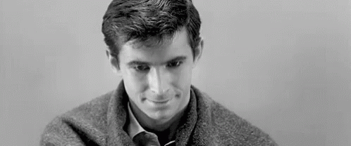 Man in Sweater and Tie Smiling
